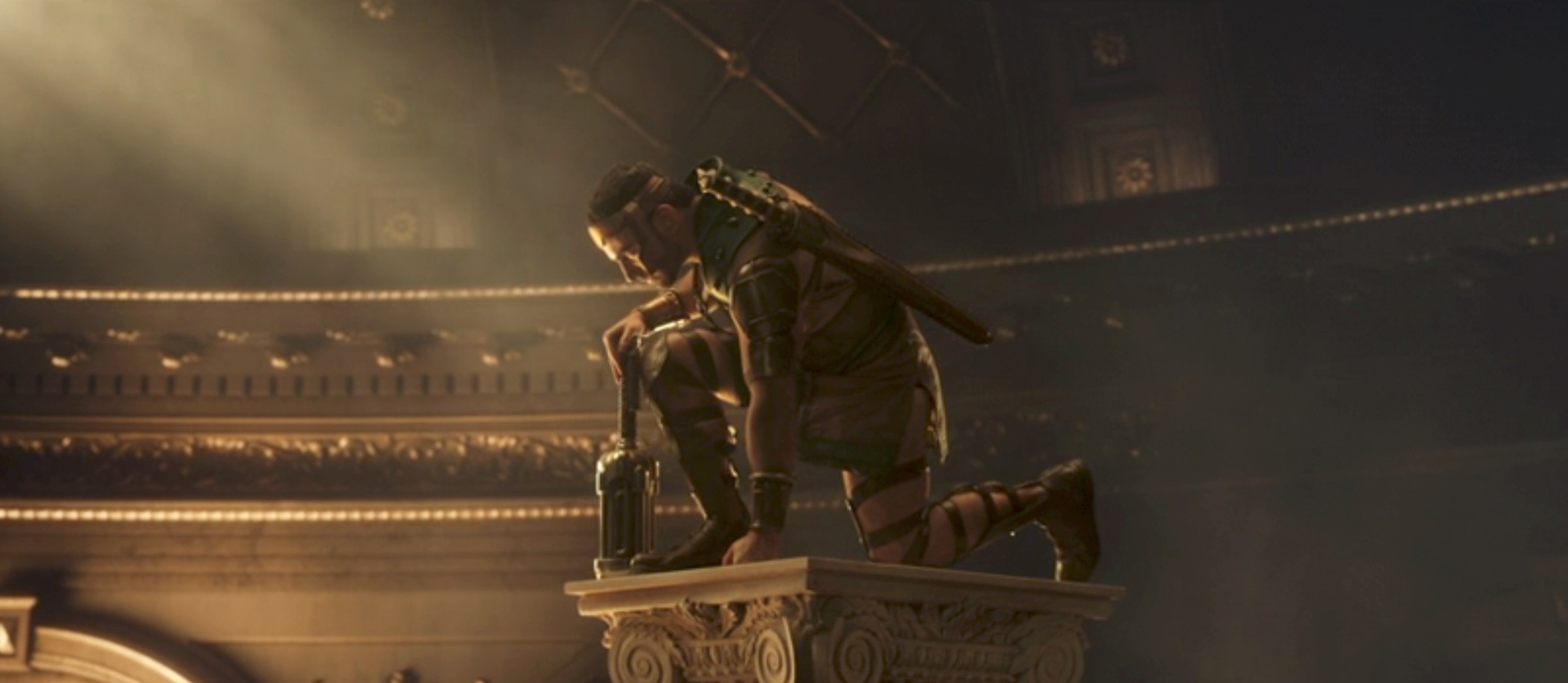 Hercules (Brett Goldstein) kneels with hammer in hand on a composite column in a shot from Thor: Love and Thunder