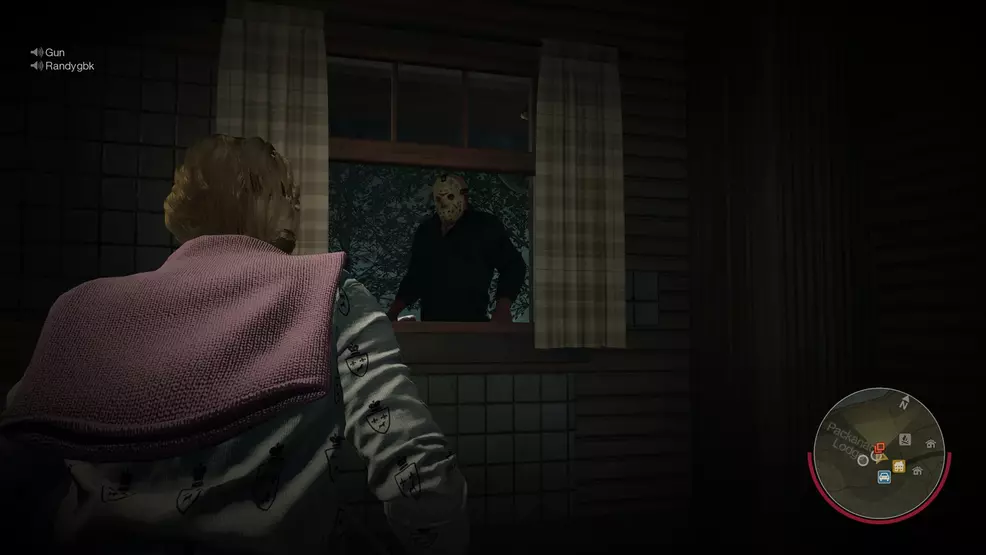 A camper inside a cabin with Jason Voorhees at the window in Friday the 13th: The Game