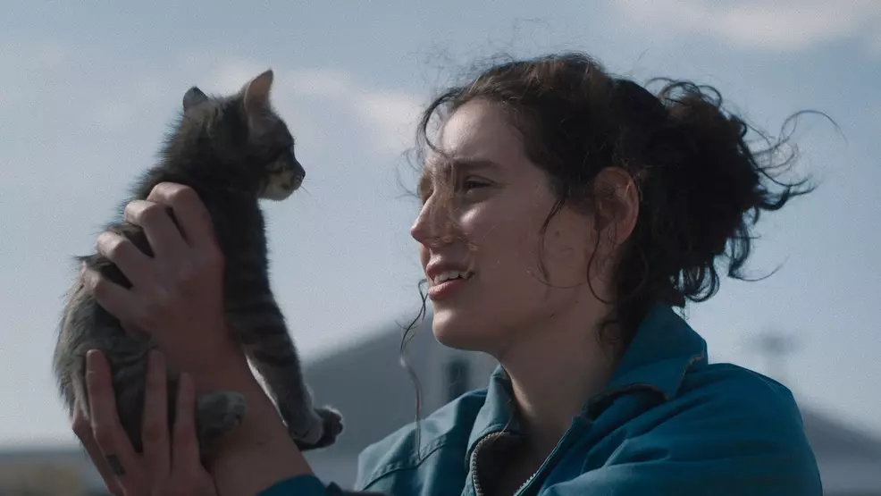 Eva Victor holding a cat.