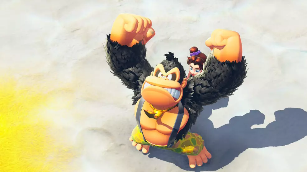 Donkey Kong with his arms in the air and Pauline on his back in Donkey Kong Bananza